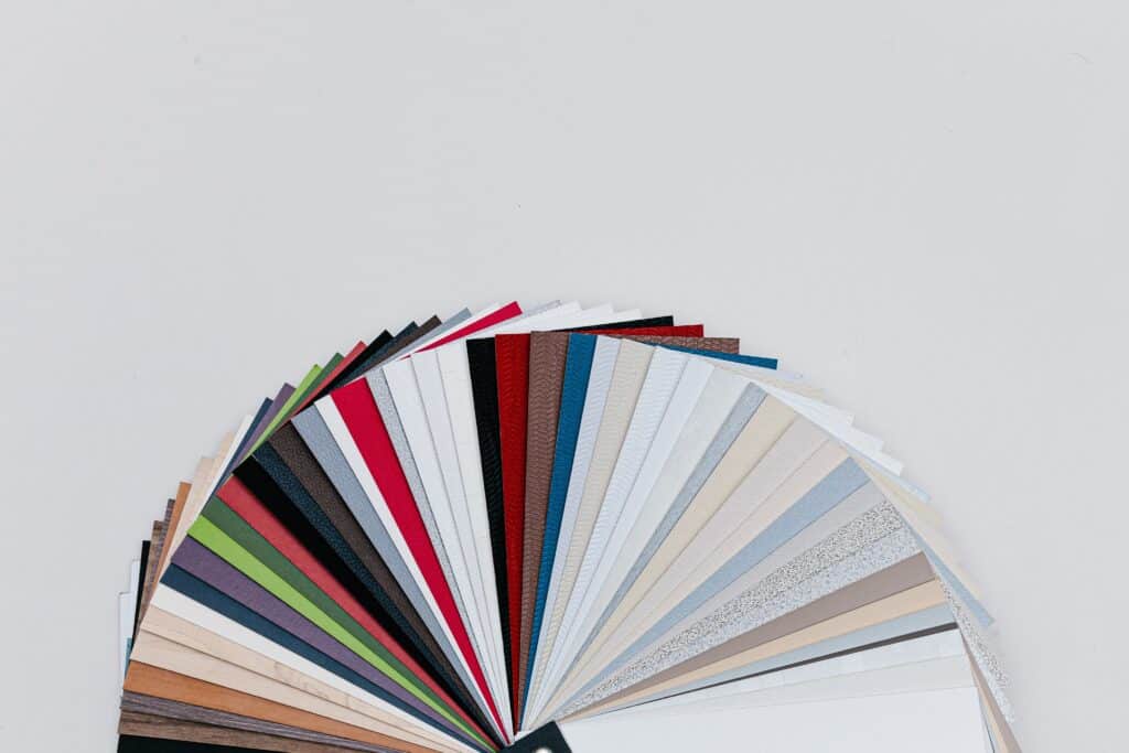 color palette of soft colors fanned out against gray backdrop - Explore how aesthetics, consistency, accessibility, speed, and mobile compatibility come together to create an impactful digital footprint. Start the journey of transforming your website into a user-centric experience with well thought-out website design. - How can website design influence conversion rates and user engagement? - your wp guy