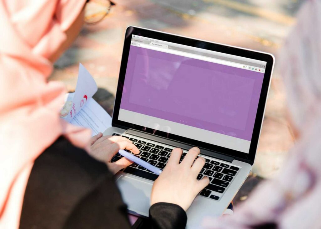 Small business owner reviewing a landing page on a laptop